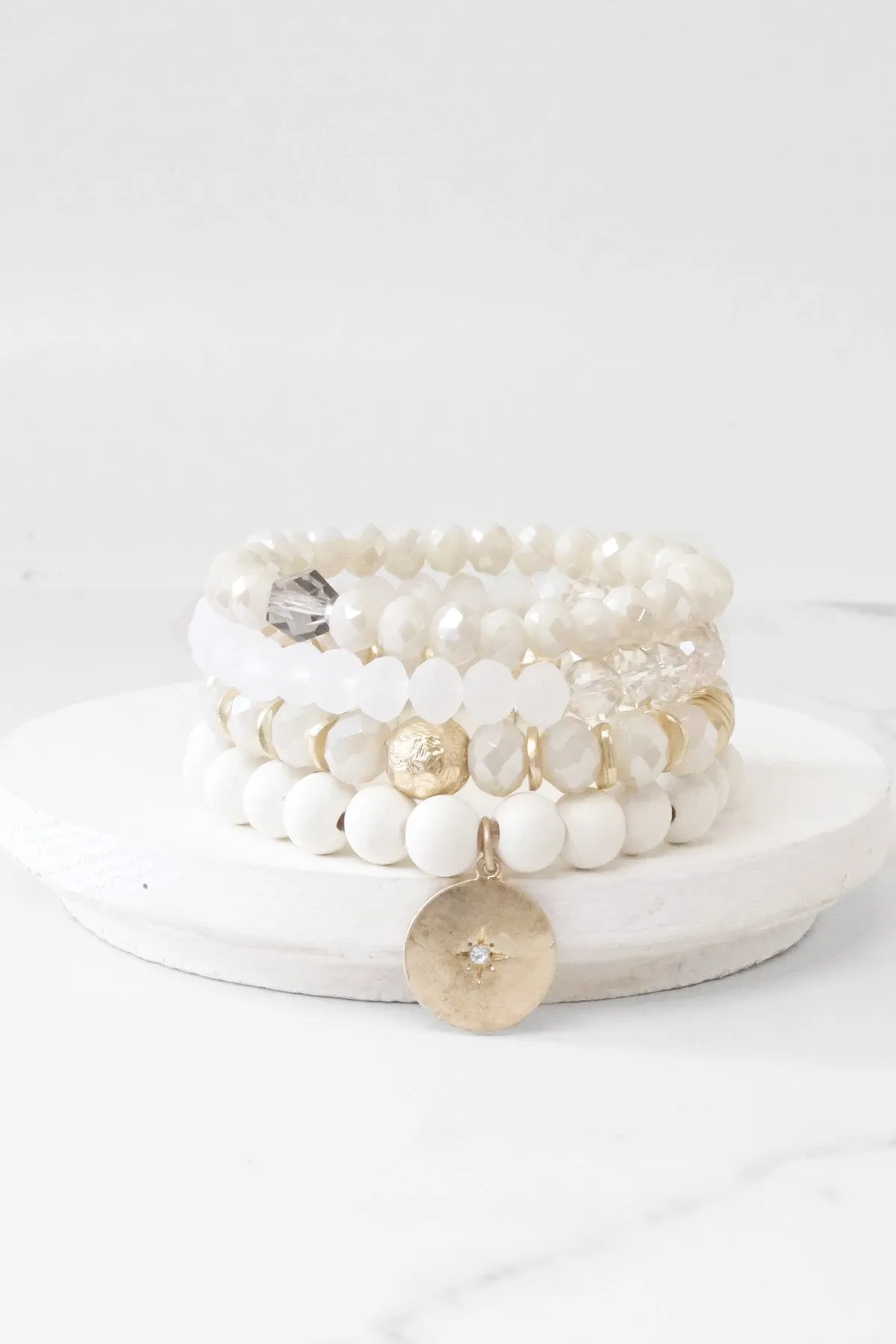 Beaded bracelets set in White Cream with a coin charm